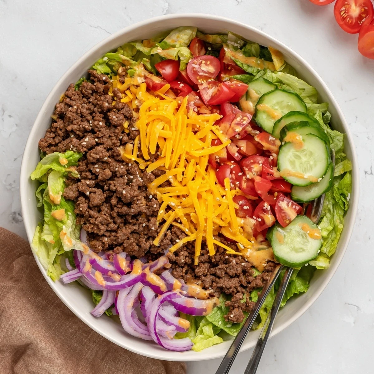 Savory burger bowls layered with seasoned beef, crisp veggies, and creamy special sauce.