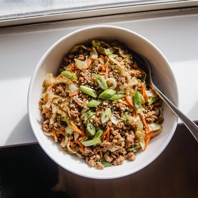 Golden ground pork and tender cabbage in a keto egg roll in a bowl